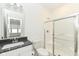 A modern bathroom features a glass door shower, grey countertop, and stylish lighting at 11392 Gammel Pl, Fishers, IN 46040