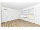 This bedroom includes wood floors, white walls, and a large window for ample sunlight at 11392 Gammel Pl, Fishers, IN 46040
