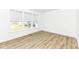 This bedroom showcases wood floors, white walls, and large windows with natural light at 11392 Gammel Pl, Fishers, IN 46040