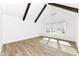 Bright bedroom featuring vaulted ceiling, dark wood beams, and ample natural light at 11392 Gammel Pl, Fishers, IN 46040