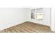 Bright bedroom featuring wood floors, white walls and trim, and a large window at 11392 Gammel Pl, Fishers, IN 46040