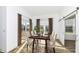 Dining room with dark wood table and upholstered chairs with sliding glass door, sliding barn door, and windows at 11392 Gammel Pl, Fishers, IN 46040