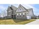 Modern exterior of a two-story home featuring brick and siding, plus a spacious three-car garage at 11392 Gammel Pl, Fishers, IN 46040