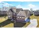 Stunning new construction home featuring brick and siding accents, a three car garage and well manicured lawn at 11392 Gammel Pl, Fishers, IN 46040