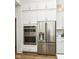 Stainless steel refrigerator and double oven appliances are adjacent to white cabinets and countertop at 11392 Gammel Pl, Fishers, IN 46040