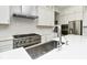 Close up of kitchen sink with view of stainless steel appliances and subway tile backsplash at 11392 Gammel Pl, Fishers, IN 46040