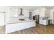 Modern kitchen with large island, stainless steel appliances, and white cabinetry at 11392 Gammel Pl, Fishers, IN 46040
