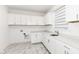 Well-lit laundry room with ample cabinetry and counter space ensures a functional and efficient space for laundry tasks at 11392 Gammel Pl, Fishers, IN 46040
