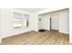 Open living room with light wood floors, white walls, large window, and a view into the entry at 11392 Gammel Pl, Fishers, IN 46040
