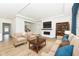 A stylish living room decorated with furniture, a fireplace, and wood floors at 11392 Gammel Pl, Fishers, IN 46040