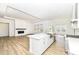 Spacious living room and kitchen feature a fireplace, white cabinets, and an island with seating at 11392 Gammel Pl, Fishers, IN 46040