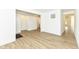 Spacious living room with light wood floors and white walls, showcasing an open layout at 11392 Gammel Pl, Fishers, IN 46040