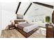 Comfortable bedroom featuring vaulted ceiling, dark wood beams, and natural light at 11392 Gammel Pl, Fishers, IN 46040