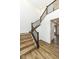 Inviting staircase featuring wood steps, modern dark railing, and wood-look floors that create a warm aesthetic at 11392 Gammel Pl, Fishers, IN 46040