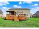 Exterior view of the house with a wooden deck and well maintained backyard at 11551 Buckskin Dr, Zionsville, IN 46077