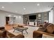 Finished basement featuring a comfortable seating area with decorative sports memorabilia and wood-look vinyl flooring at 11551 Buckskin Dr, Zionsville, IN 46077