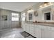 This bathroom has shiplap walls, double sinks, and a tiled walk-in shower with a frosted window at 11551 Buckskin Dr, Zionsville, IN 46077