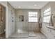 Bathroom featuring a tiled walk-in shower, a window providing natural light, and neutral color tones at 11551 Buckskin Dr, Zionsville, IN 46077