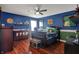 Themed bedroom with rich colors, hardwood floors, bed, and decor adding character to the room at 11551 Buckskin Dr, Zionsville, IN 46077