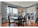 Bright dining area with natural light, stylish furnishings, and access to the deck at 11551 Buckskin Dr, Zionsville, IN 46077
