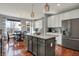 Modern kitchen with stainless steel appliances, granite countertops, and a large center island at 11551 Buckskin Dr, Zionsville, IN 46077