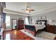 Spacious main bedroom featuring a ceiling fan, wood floors, and a large window with natural light at 11551 Buckskin Dr, Zionsville, IN 46077