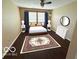 Relaxing bedroom featuring a queen bed, matching nightstands, and natural light through the window at 11876 Wapiti Way, Noblesville, IN 46060