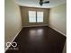 Well-lit bedroom featuring wood floors and view of the backyard at 11876 Wapiti Way, Noblesville, IN 46060
