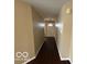 Clean hallway featuring dark wood floors and access to multiple rooms at 11876 Wapiti Way, Noblesville, IN 46060