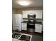 Kitchen with stainless steel appliances, white cabinets, and hardwood floors at 11876 Wapiti Way, Noblesville, IN 46060