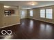 Bright living room with hardwood floors and multiple windows for natural light at 11876 Wapiti Way, Noblesville, IN 46060