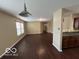 Spacious living area with wood floors connecting to dining and kitchen at 11876 Wapiti Way, Noblesville, IN 46060