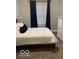 Bedroom with a comfortable bed and a window with elegant curtains at 1216 N Holmes Ave, Indianapolis, IN 46222