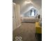 Bonus bedroom with a comfortable bed, bench and light-filled windows at 1216 N Holmes Ave, Indianapolis, IN 46222