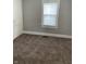 Bedroom featuring a neutral color palette and large window providing natural light at 1216 N Holmes Ave, Indianapolis, IN 46222
