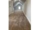 Finished bonus room with neutral paint and cozy carpeting provides extra living space at 1216 N Holmes Ave, Indianapolis, IN 46222