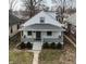 Charming home featuring a cozy front porch and well-maintained landscaping at 1216 N Holmes Ave, Indianapolis, IN 46222