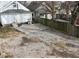 Overhead shot of gravel parking area and the rear of the home showing door and siding at 1216 N Holmes Ave, Indianapolis, IN 46222