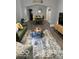 A bright and beautifully styled living room featuring an archway to the dining room at 1216 N Holmes Ave, Indianapolis, IN 46222