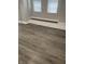 A bright, open-concept space featuring hardwood floors and neutral wall paint at 1216 N Holmes Ave, Indianapolis, IN 46222