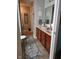 Hall bathroom featuring double sinks, decor, and patterned rug at 13124 S Elster Way, Fishers, IN 46037