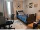 Cozy bedroom featuring a bed, desk, and decorative wall art at 13124 S Elster Way, Fishers, IN 46037