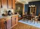 Open concept: kitchen flows into the dining area with wood table and hardwood floors at 13124 S Elster Way, Fishers, IN 46037