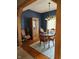 Dining room with blue walls, hardwood floors, wooden table and chairs under a chandelier at 13124 S Elster Way, Fishers, IN 46037