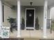 Inviting covered front porch with rocking chairs, decorative plants, and charming welcome decor creates a cozy entrance at 13124 S Elster Way, Fishers, IN 46037