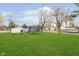 A vast backyard with a trampoline and garden boxes providing an inviting space for outdoor enjoyment at 1407 Hannibal St, Noblesville, IN 46060