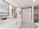 Modern bathroom with double vanity, stylish mirrors, and a shower with tasteful tile and neutral colored accents at 1407 Hannibal St, Noblesville, IN 46060