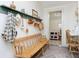 Inviting entryway with a wooden bench and coat rack, leading to a functional laundry area at 1407 Hannibal St, Noblesville, IN 46060