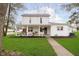 Charming two-story home featuring a covered porch with swing and well-maintained lawn at 1407 Hannibal St, Noblesville, IN 46060