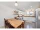Bright kitchen featuring a farmhouse table, stainless steel appliances, and white cabinets at 1407 Hannibal St, Noblesville, IN 46060